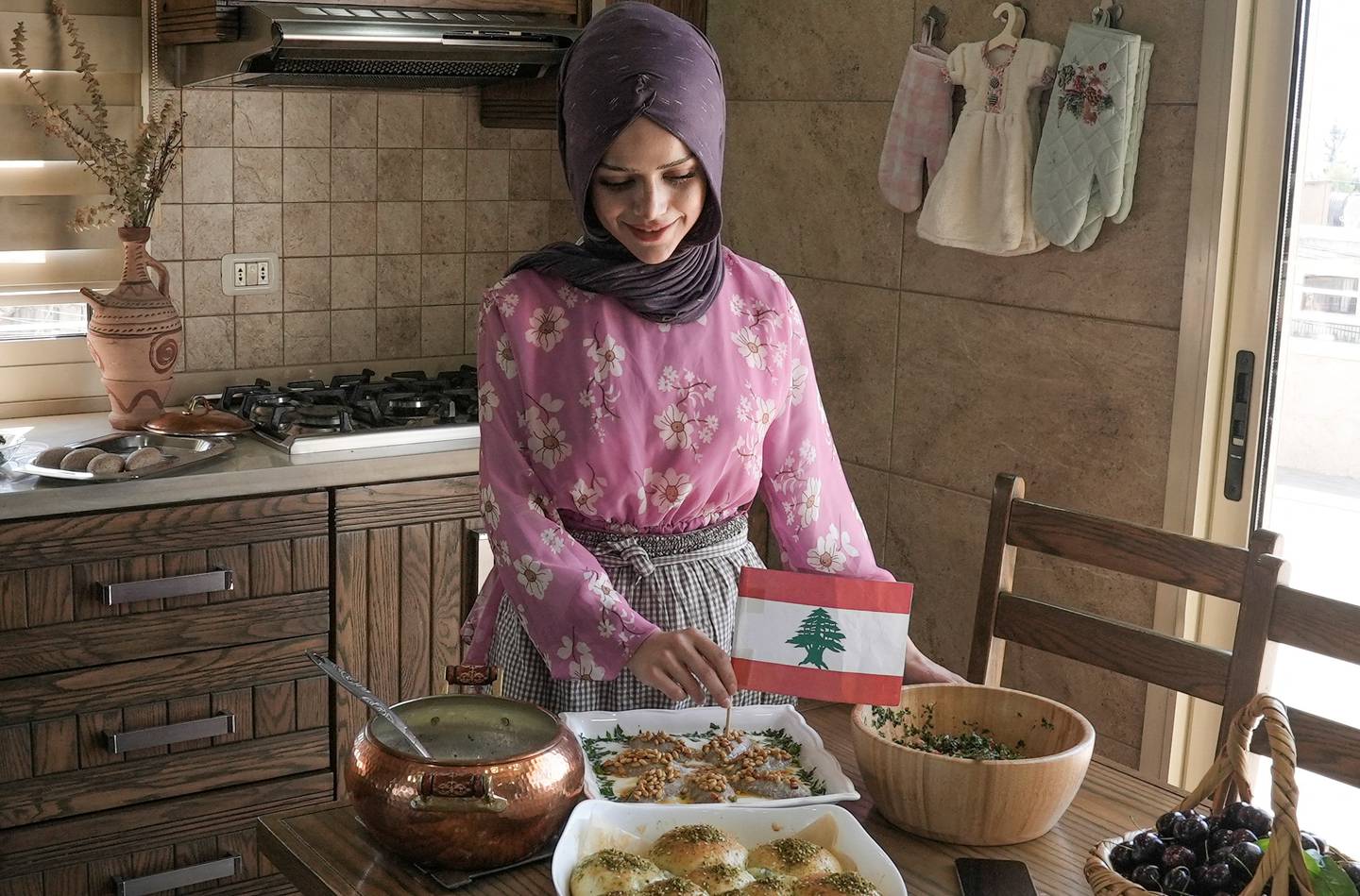 TikTok chef Abir El Saghir places the Lebanese flag on a dish in Jeb Jennin, west Bekaa, Lebanon. Reuters