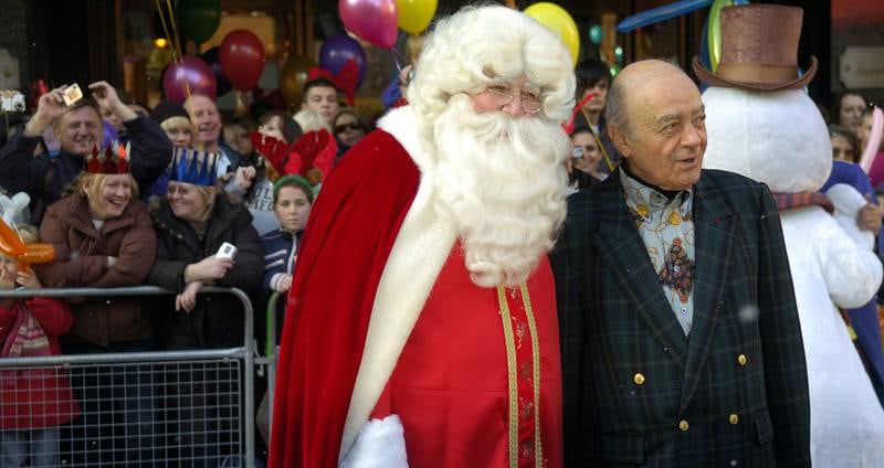 Mohamed Al Fayed accompanied by Santa Claus at Harrods department store during the annual Christmas Parade in 2007.