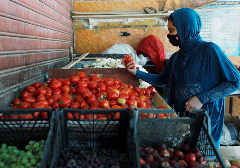 A woman buys vegetables from a cafe transformed into a fruit and vegetable shop in Cairo, Egypt. Reuters