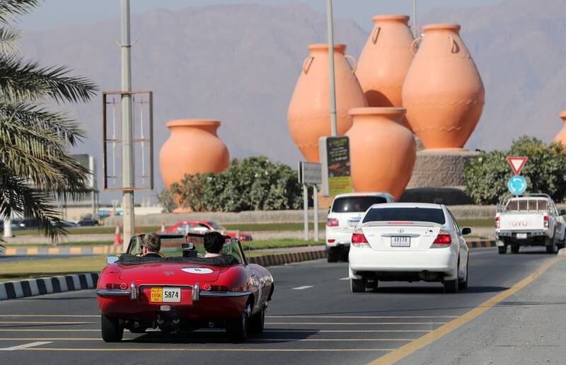 Cars drive through Dibba during the first leg of Day 2.