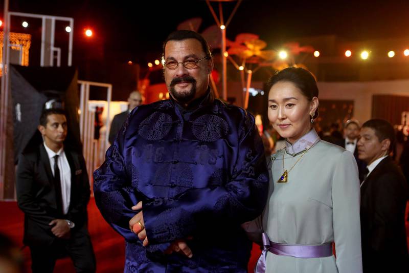 Steven Seagal poses with his wife, Erdenetuya, on the red carpet during the closing ceremony of El Gouna Film Festival. AFP