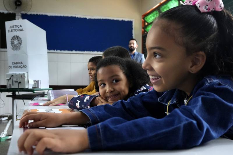 Pupils take part in a simulated election using electronic voting machines at Santa Maria Public School in Brasilia. Brazilians head to the polls on October 2 to elect a president, vice president, governor and senators. AP