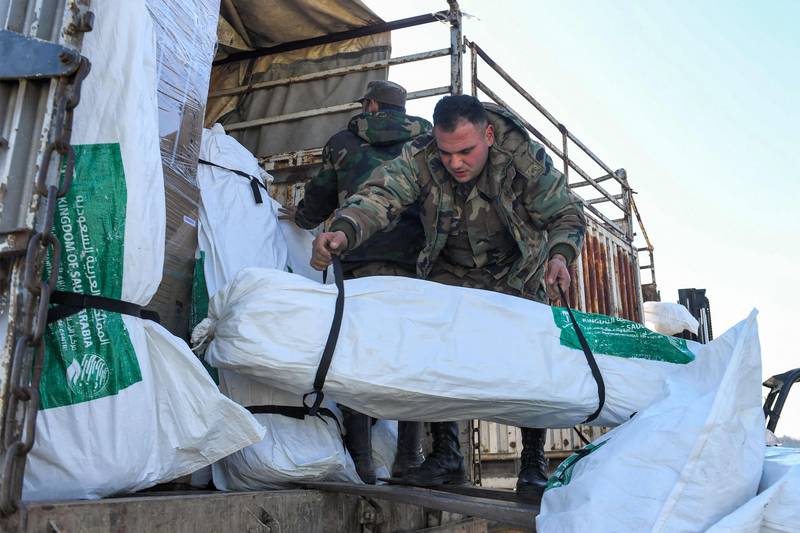 Humanitarian aid relief packages provided by Saudi Arabia being unloaded at Aleppo International Airport in northern Syria. AFP