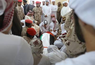 Family members on Thursday with the body of Juma Al Kaabi before funeral prayers in Ras Al Khaimah. The UAE Ambassador to Afghanistan died in a French hospital this week from injuries sustained in a bomb blast in Kandahar in January. Satish Kumar / The National