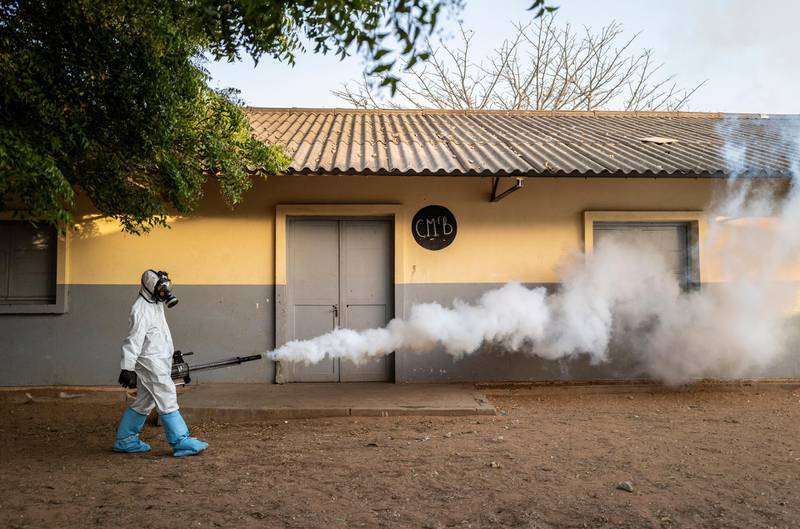 A municipal worker sprays disinfectant at a school in Dakar, Senegal. AP Photo