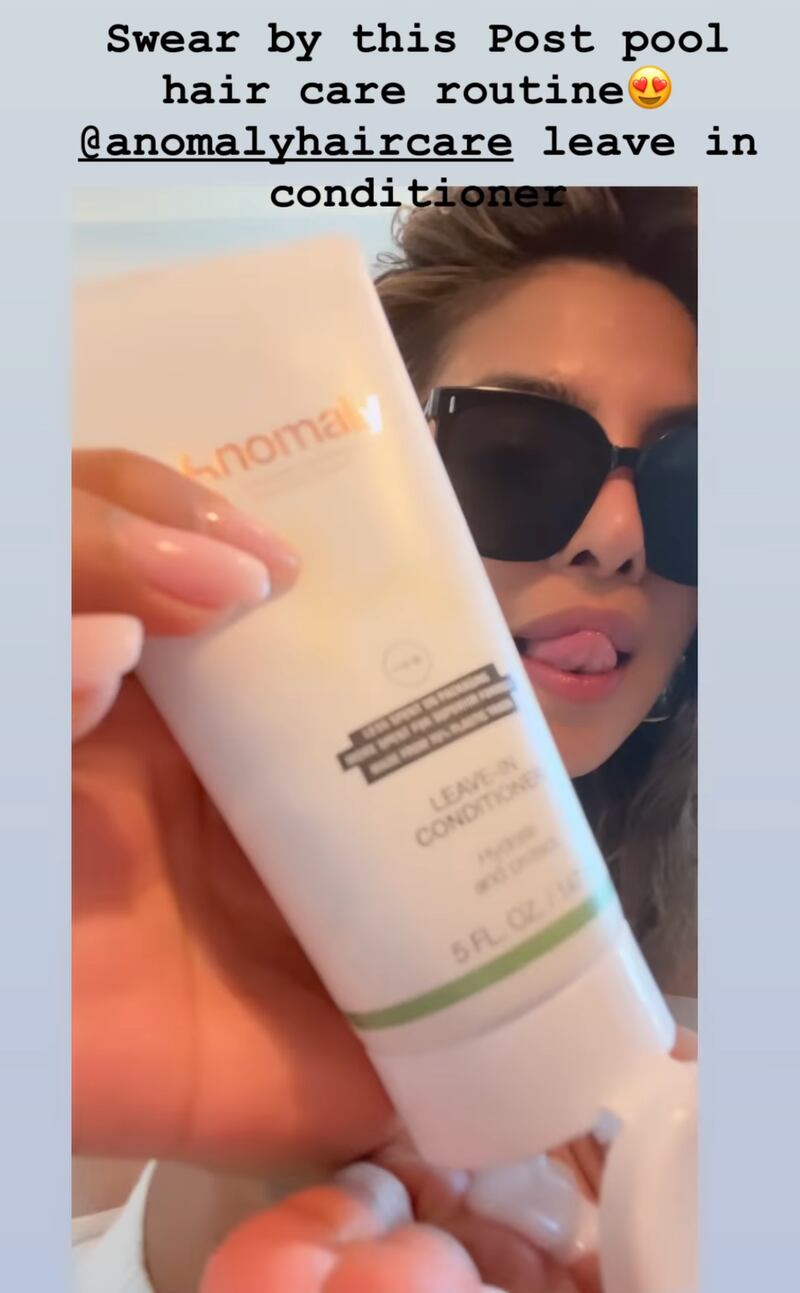 Chopra using her Anomaly Haircare leave-in conditioner after spending the day in the pool. Photo: Instagram / Priyanka Chopra