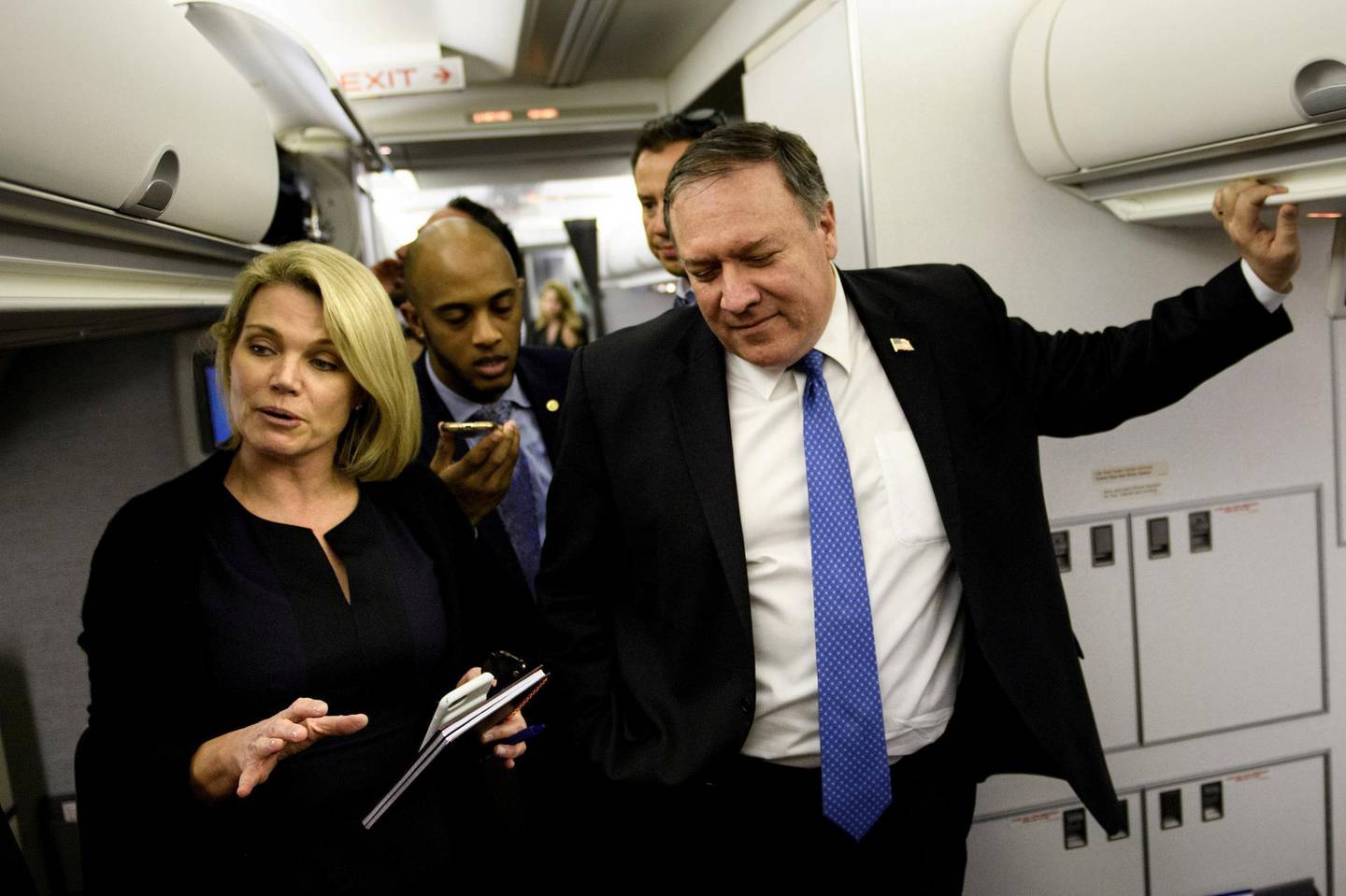 FILE PHOTO: Spokesperson Heather Nauert (L) speaks as U.S. Secretary of State Mike Pompeo dialogues with reporters in his plane while flying from Panama to Mexico, October 18, 2018. Brendan Smialowski/Pool via REUTERS/File Photo