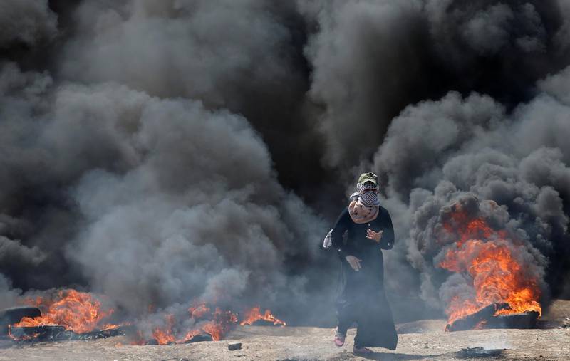 A female Palestinian demonstrator gestures during a protest against US embassy move to Jerusalem and ahead of the 70th anniversary of Nakba, at the Israel-Gaza border, east of Gaza City. Mohammed Salem / Reuters
