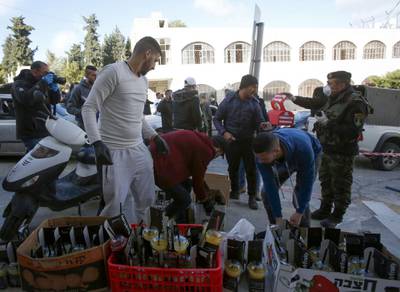 Palestinian volunteers prepare supplies to deliver to a hotel under quarantine in the West Bank city of Bethlehem a day after a lockdown on the city was announced. AFP