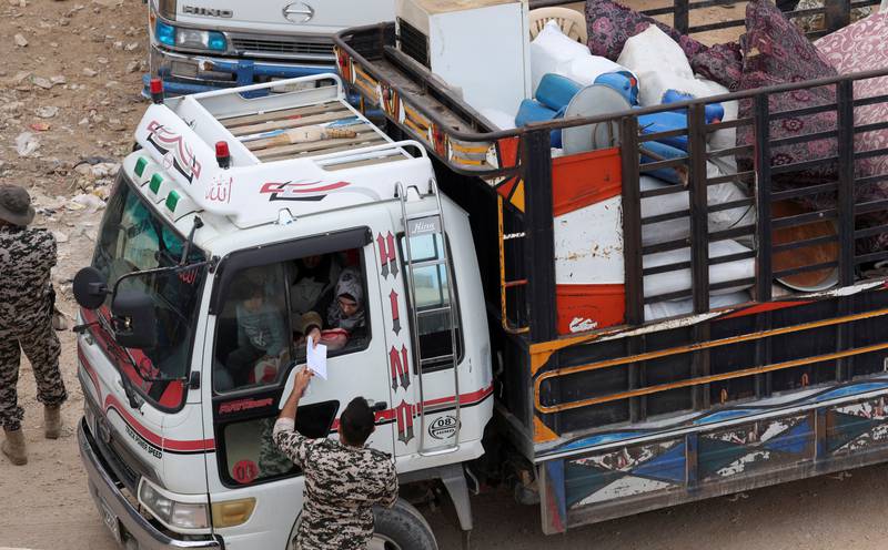 Lugging suitcases, power generators, fridges and even chickens, about 700 Syrians who had agreed to cross over gathered from early morning in a desolate north-eastern border zone.