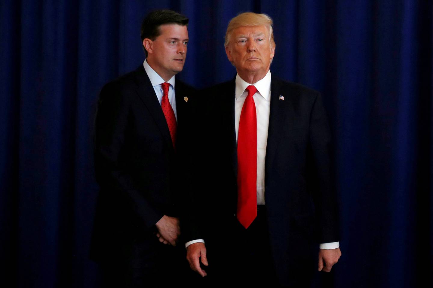 FILE PHOTO: White House Staff Secretary Rob Porter (L) reminds U.S. President Donald Trump he had a bill to sign after he departed quickly following remarks at his golf estate in Bedminster, New Jersey U.S., August 12, 2017.  REUTERS/Jonathan Ernst/File Photo