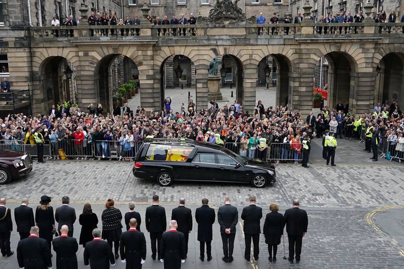 Crowds watch as the hearse continues its journey to the Palace of Holyroodhouse from Balmoral. PA