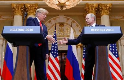 FILE PHOTO: U.S. President Donald Trump and Russia's President Vladimir Putin shake hands during a joint news conference after their meeting in Helsinki, Finland, July 16, 2018. REUTERS/Kevin Lamarque/File Photo