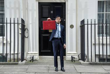 UK finance minister Rishi Sunak holds the budget box ahead of the budget. Reuters
