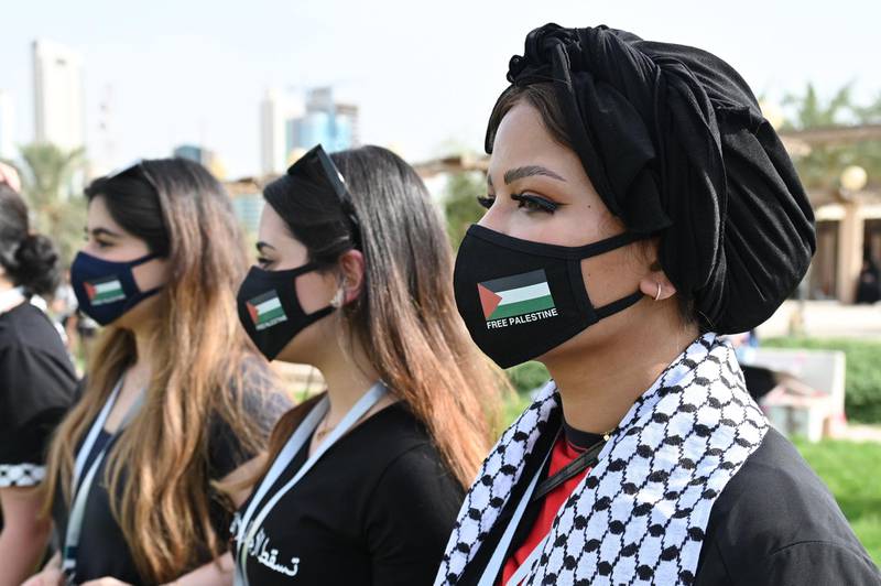 Protesters wearing coronavirus masks emblazoned with the flag of Palestine gather at Irada Square, outside the National Assembly in Kuwait City, Kuwait. EPA