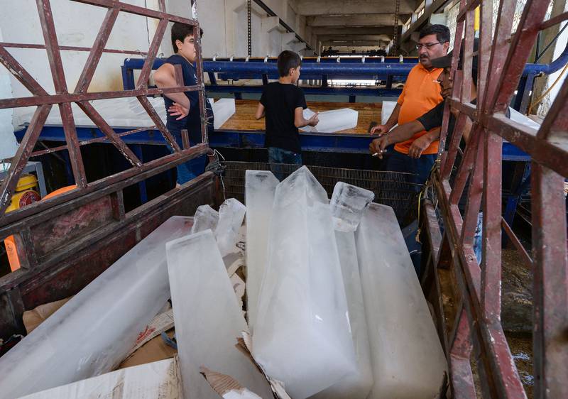 Iraqis buy ice blocks from a factory in the northern city of Mosul, amid power outages and soaring temperatures.