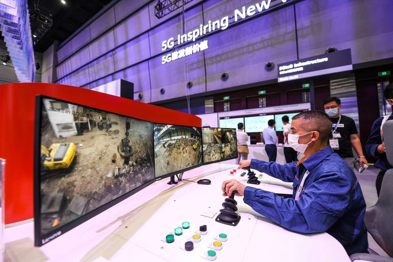 A worker uses a remote control system supported by Huawei 5G technology to control a crane located in Hunan province, during the Huawei Connect Conference in Shanghai on September 23, 2020. China OUT
 / AFP / STR
