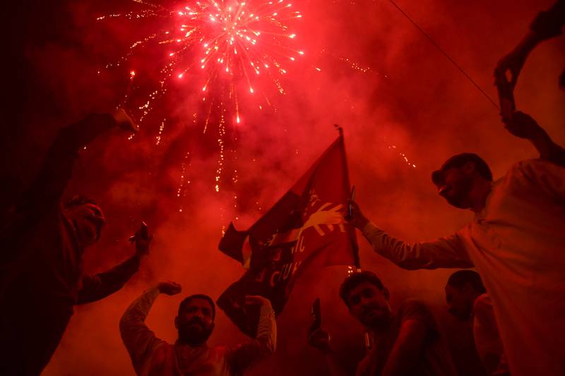 Pakistan Peoples Party supporters celebrate on the street after a Supreme Court ruling that the National Assembly should reconvene after it was dissolved by Prime Minister Imran Khan.  AFP