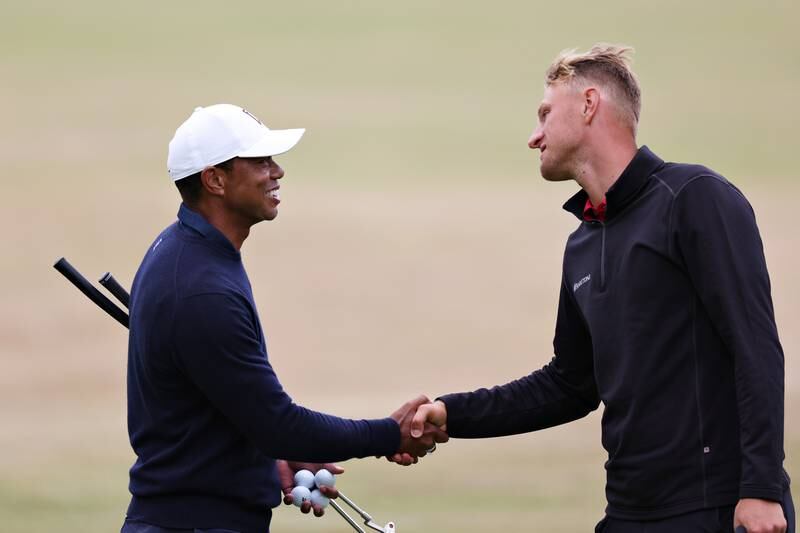 Adrian Meronk of Poland and Tiger Woods of The United States shake hands on the 18th during a practice round. Getty