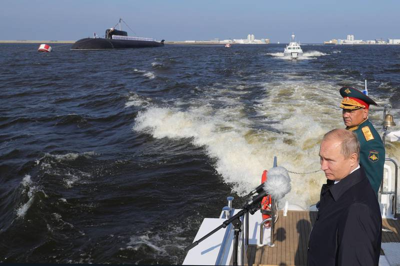 Russian President Vladimir Putin and Defence Minister Sergei Shoigu inspect warships during the Navy Day parade in Saint Petersburg.   AFP / SPUTNIK / Mikhail KLIMENTYEV