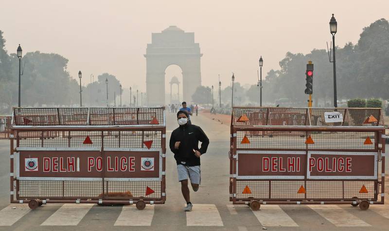 An Indian jogger wears a pollution mask early morning amidst light smog in New Delhi, India, Monday, Oct. 28, 2019. The national capital's air quality dropped to the season's worst on the morning after the Hindu festival of Diwali, but the situation was still better than the last three years, according to government agencies. (AP Photo/Manish Swarup)