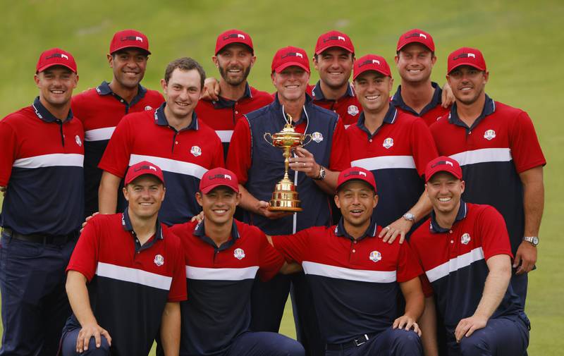 US captain Steve Stricker and players pose for photos with the Ryder Cup. Reuters