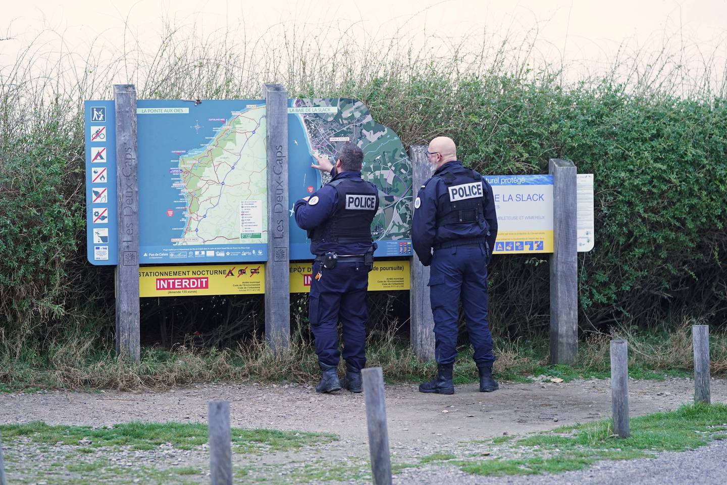 French police look at a map of the coast at Wimereux on Thursday morning, in northern France, at a stretch of beach believed to be used by migrants looking to cross the English Channel. PA