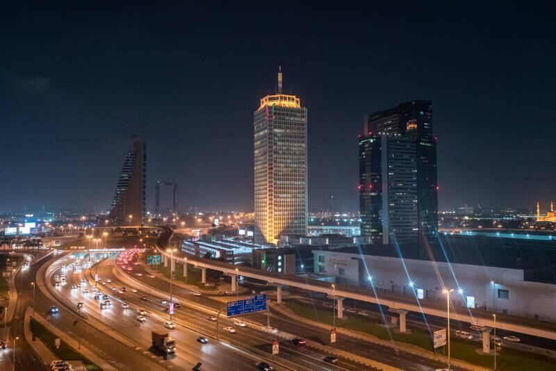 The World Trade Centre in Dubai at night. Alamy