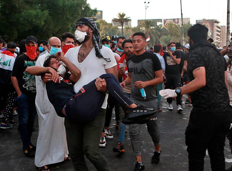 An injured protestor is rushed to a hospital during a demonstration in Baghdad, Iraq. AP Photo