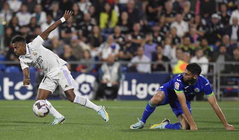Real Madrid forward Rodrygo breaks clear of a challenge from Getafe defender Domingos Duarte. AFP