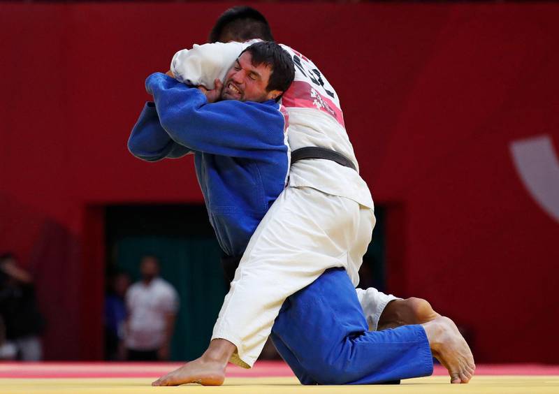 Judo - 2018 Asian Games - Men’s -73kg, Bronze Medal Match - JCC Plenary Hall, Jakarta, Indonesia - August 30, 2018 - Bektur Rysmambetov of Kyrgyzstan and Victor Scvortov of United Arab Emirates in action. REUTERS/Issei Kato