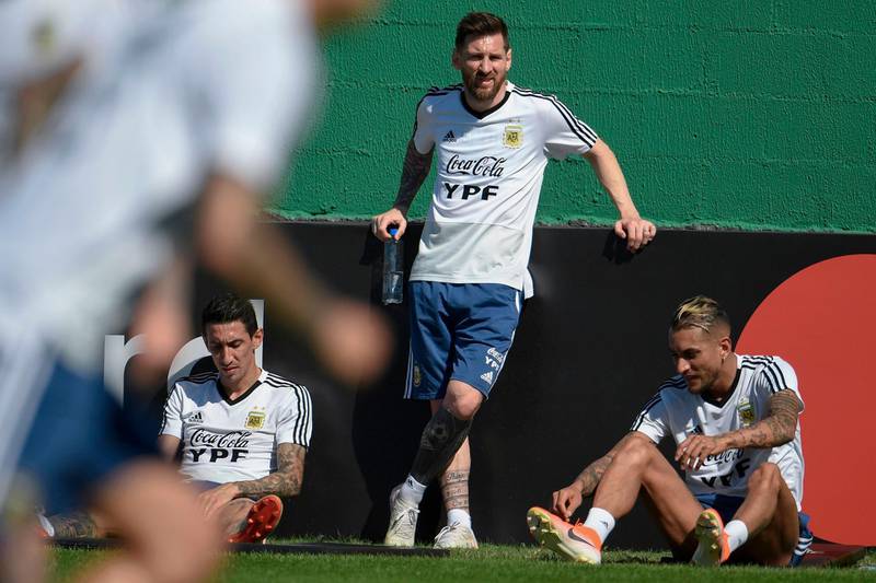 From left: Angel Di Maria, Lionel Messi and Roberto Pereyra take time out from training. AFP