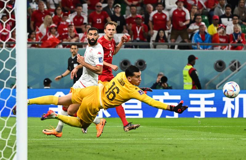 Tunisia goalkeeper Aymen Dahmen dives for the ball. AFP