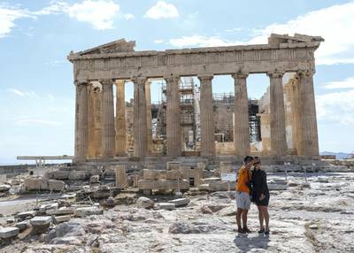 ATHENS, GREECE - MAY 23: Tourists hike around the Acropolis on May 23, 2020 in Athens, Greece. After months of being on lockdown due to the coronavirus, Greece has opened its famed museums and tourist destinations while relaxing restrictions on movement and shopping on the mainland in recent days. (Photo by Byron Smith/Getty Images)