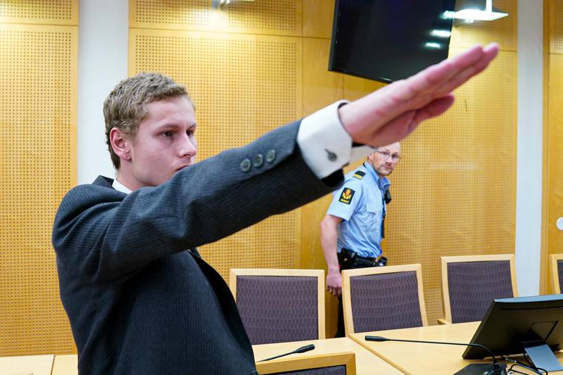 epa07829709 Norwegian suspect Philip Manshaus makes the Nazi salute as he appears at the Oslo District Court for a hearing, in Oslo, Norway, 09 August 2019. Norwegian Philip Manshaus, 22-year-old, who is accused of an attempted terrorist attack in connection with a gun attack on an Oslo mosque in August 2019, appeared on the day at court regarding his imprisonment conditions. He is also charged with the murder of his 17-year-old half-sister, whose body was found on same day as the shooting.  EPA/HEIKO JUNGE  NORWAY OUT