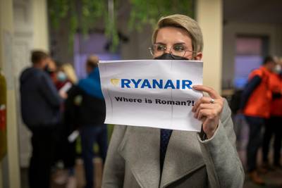 A woman holds a poster reads "where is Roman Protasevich?!" as she waits to see passengers at the International Airport outside Vilnius. AP Photo