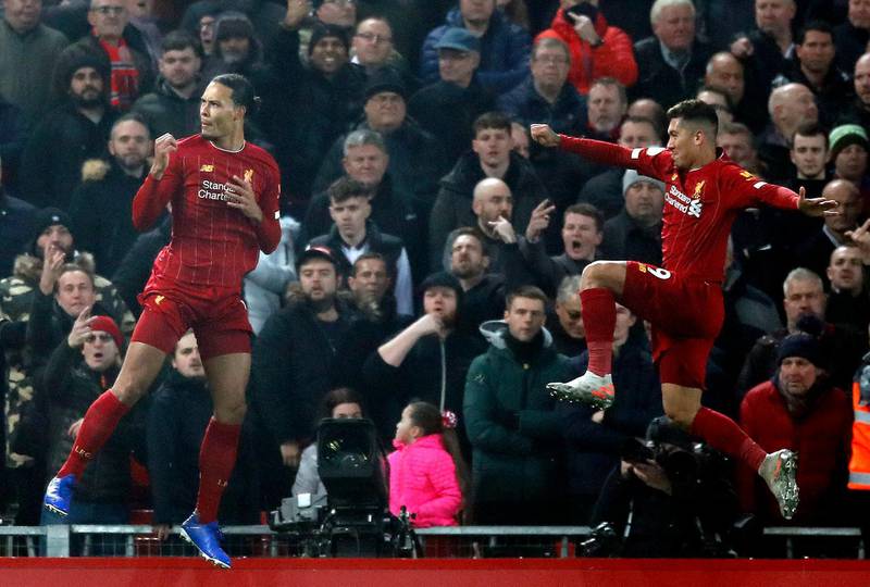 Virgil van Dijk (left) celebrates scoring Liverpool's first goal with Roberto Firmino. PA