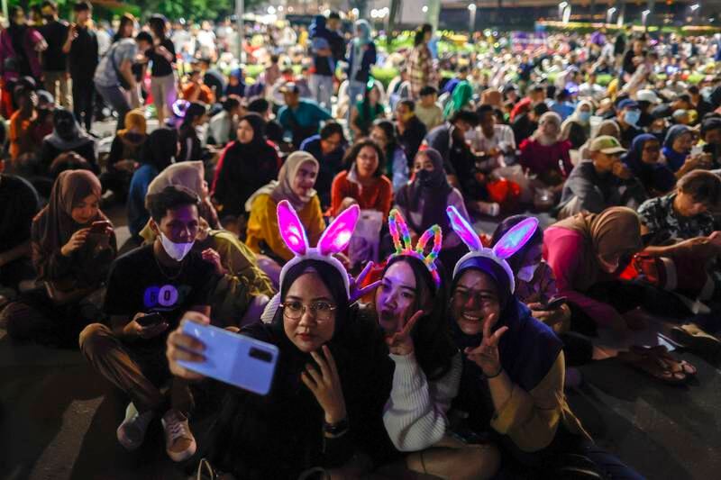 Selfies are taken as revellers gather for New Year's Eve celebrations at the main roundabout in Jakarta, Indonesia. EPA