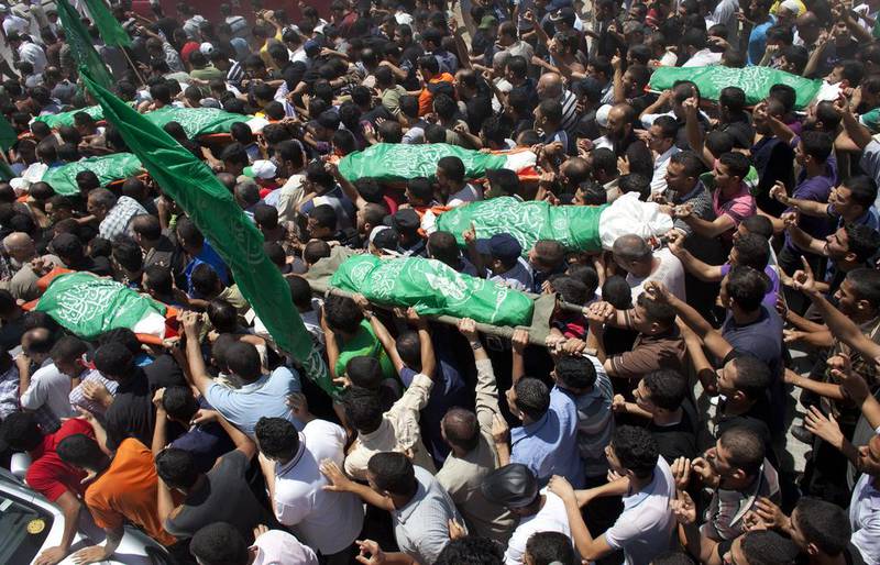 Palestinians carry the bodies of the  ight members of the Al Hajj family who were killed in a strike early morning in Khan Younis refugee camp, southern Gaza Strip on July 10, 2014. Heidi Levine for The National