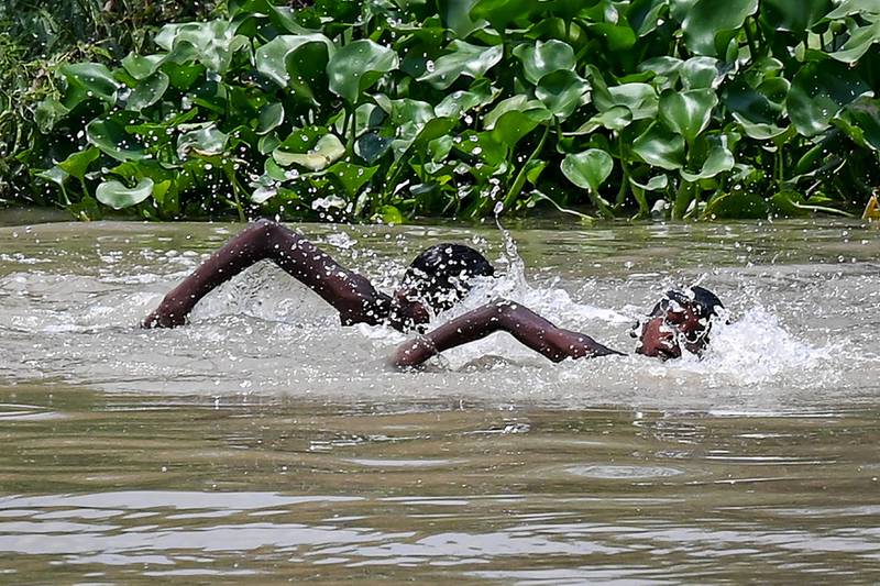 Children swim in a canal on a hot summer afternoon in New Delhi.  AFP