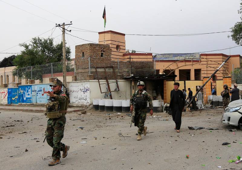 Afghan security forces keep watch at the site of blasts in Jalalabad, Afghanistan, on May 13, 2018. Parwiz / Reuters
