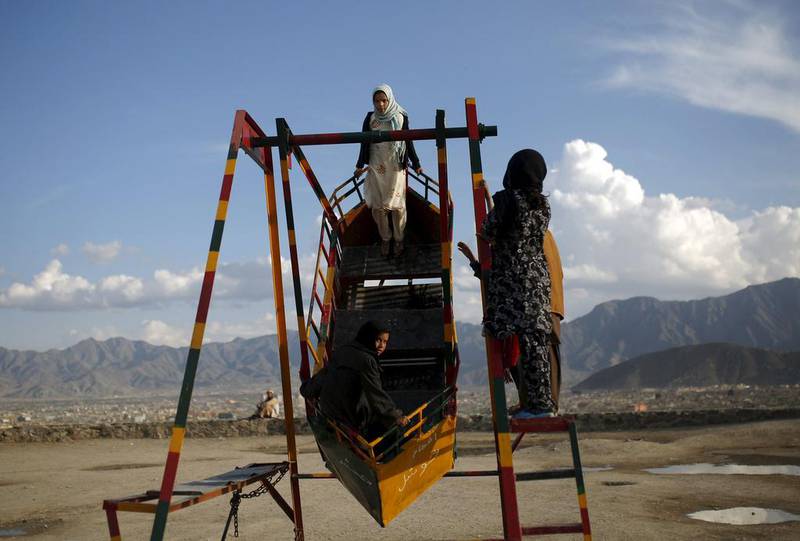 Afghan girls play on a swing in Kabul, Afghanistan.  Ahmad Masood / Reuters