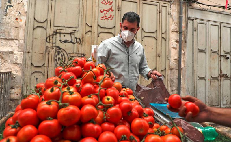 A Palestinian man buys from a street vendor in the city of Nablus.  AFP