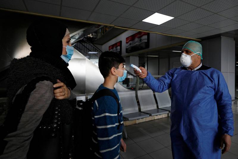 A health official tests passengers as part of security measures to avoid coronavirus in the country, at Damascus international airport, Damascus, Syria March 9, 2020. Reuters
