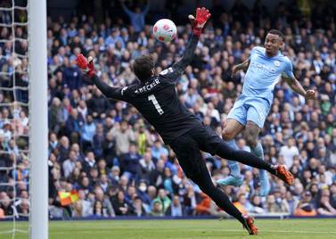 Manchester City's Gabriel Jesus, right, scores his side's second goal during the English Premier League soccer match between Manchester City and Liverpool, at the Etihad stadium in Manchester, England, Sunday, April 10, 2022.  (AP Photo / Jon Super)