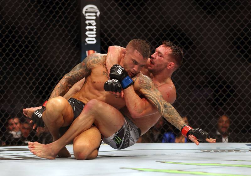 Dustin Poirier and Michael Chandler fight during their lightweight fight at UFC 281. AFP