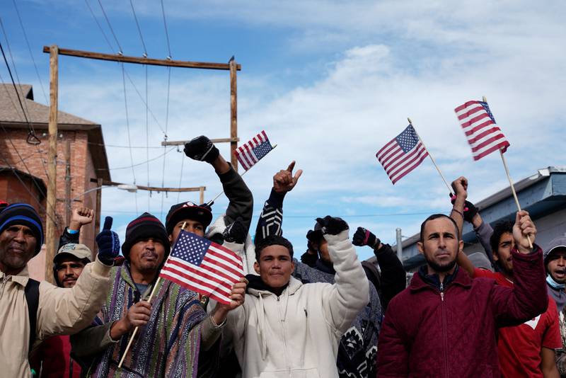 Venezuelan migrants wave American flags during a protest to demand an end to the immigration policy called Title 42. Reuters