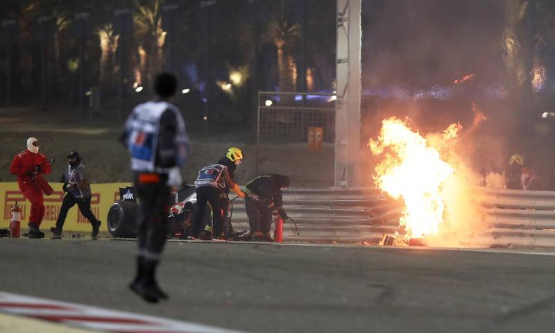 Stewards attempt to extinguish flames at the crash scene after Haas' Romain Grosjean crashed out at the start of the Bahrain GP on Sunday. Reuters
