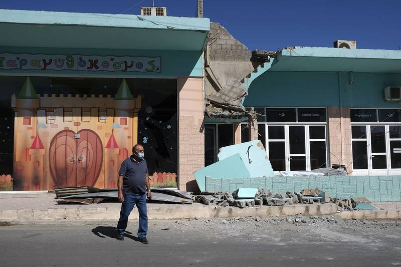 A man stands outside a damaged building after a strong earthquake in Arkalochori village on Crete. Photo: AP