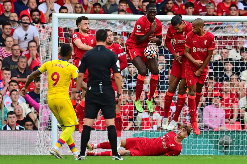 Jordan Ayew  hits his free kick into a wall of Liverpool players. AFP